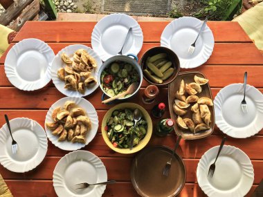 Balaton Gölü 'nün kuzeyindeki Macaristan' da salata ve ravioli ile ahşap bir masanın üzerindeki kahvaltı masasının üst görüntüsü..