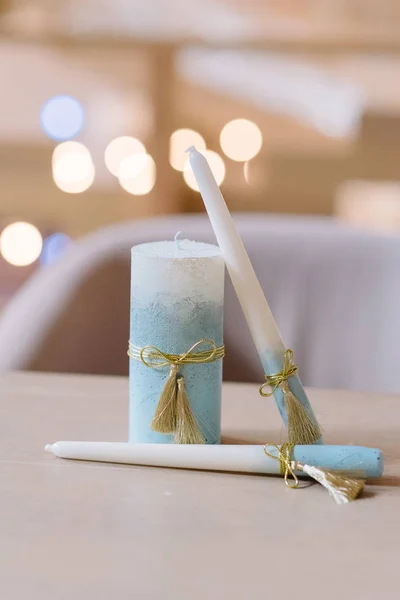 Candles for wedding tradition. The blue candles decorated with lace