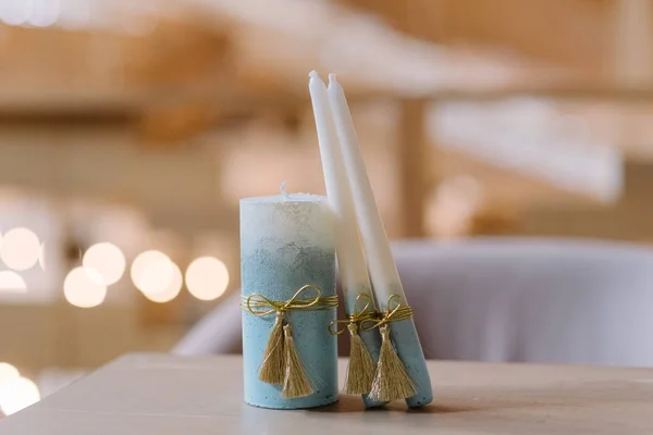 Candles for wedding tradition. The blue candles decorated with lace