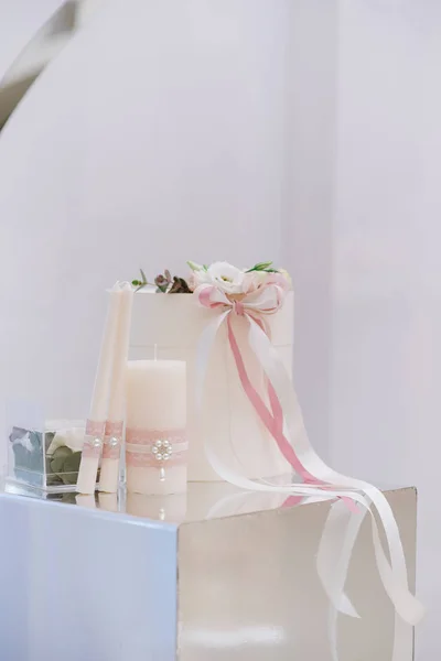 Nice accessories for a beautiful wedding ceremony on a mirror stand. Big wedding box for gifts and money