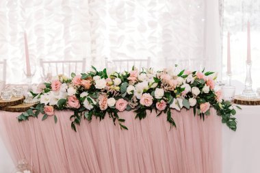 Luxurious and large composition of fresh flowers. Pink and white eustoma on the wedding table. clipart