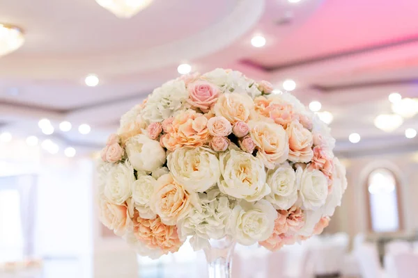 Trendy flower decor for a classic wedding in the restaurant s banquet hall.