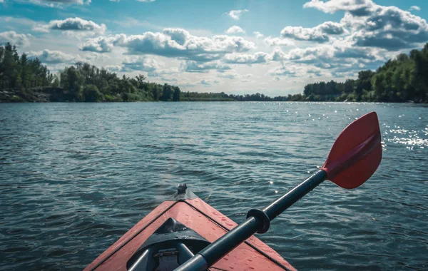 Swimming on kayaks. Rear view of kayaking on Desna river together with beautiful clouds in the backgrounds