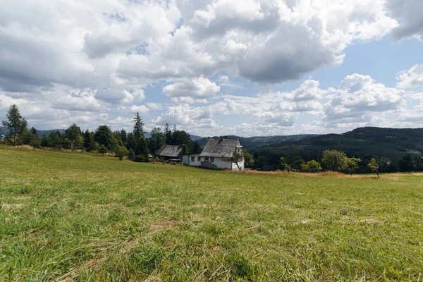 Little house on hills of Polish Beskids in summer day