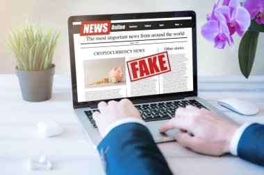 Adam laptop ekranında sahte haberler okuyor. Model web sitesi. Gazete ve internet portalı. yanlış bilgilendirme ve propaganda konsepti
