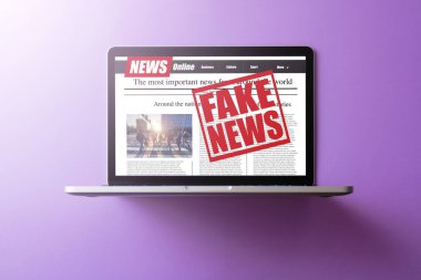 Online fake news on a laptop screen. Mockup website. Newspaper and portal on internet. concept of disinformation and propaganda