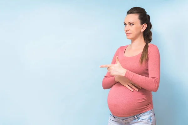 Young Beautiful Pregnant Woman Isolated Blue Background Pointing Finger Side Stock Image