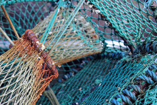 Vintage blue rope fishing , lobster post , close up of weathered and rusty detail, background image or pattern for fishing or coastal towns