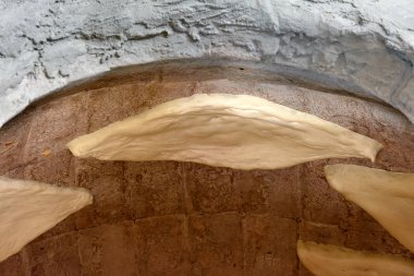 Baking Shotis Puri in tone - traditional Georgian stone oven clipart