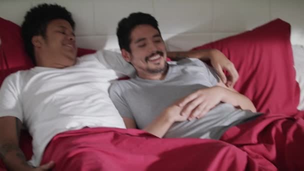 Jovens homens gays rindo e relaxando na cama em casa — Vídeo de Stock