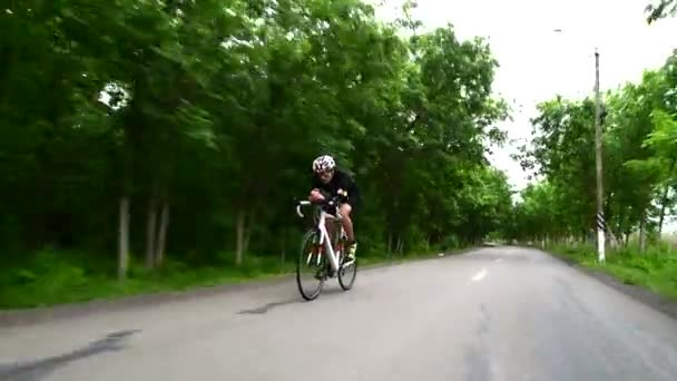 Pro bicyclist cycling road bike, sport concept, mountain road at sunset — Stock Video