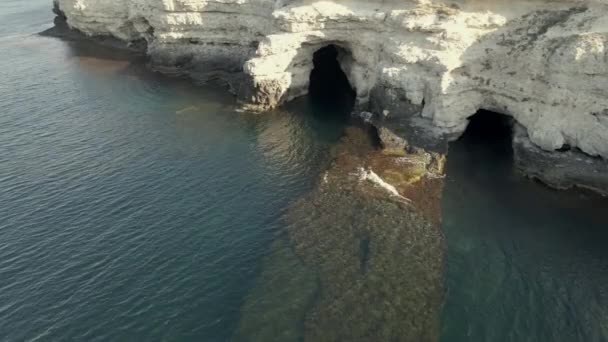 Arch shape grotto in ocean at storm, drone view 4k footage slow motion — Stock Video