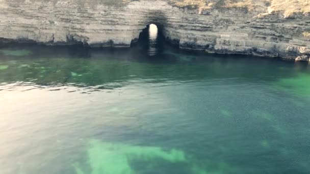 Arch shape grotto in ocean at storm, drone view 4k footage slow motion — Stock Video