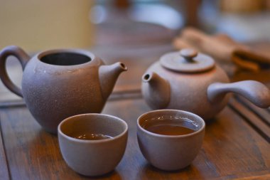 Çin çay servisi çay için: ahşap stand, kil bardak çay ve çaydanlıklar yakın çekim ile