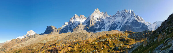 Panorama of the Alpine mountains at sunset, greeting card or banner