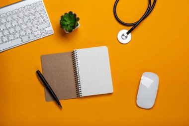 Doktorun tablo stetoskop klavye: Not defteri ve metniniz için alanı olan kalem ile üstten görünüm.