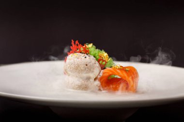 Moleküler modern mutfağı gravlax alabalık sarımsak dondurma siyah bir arka plan ile.