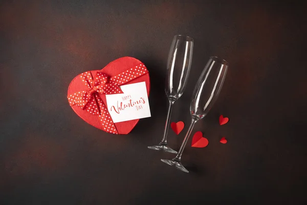 Valentine\'s Day with glasses box of chocolates in the form of a heart and a note. Top view with copy space