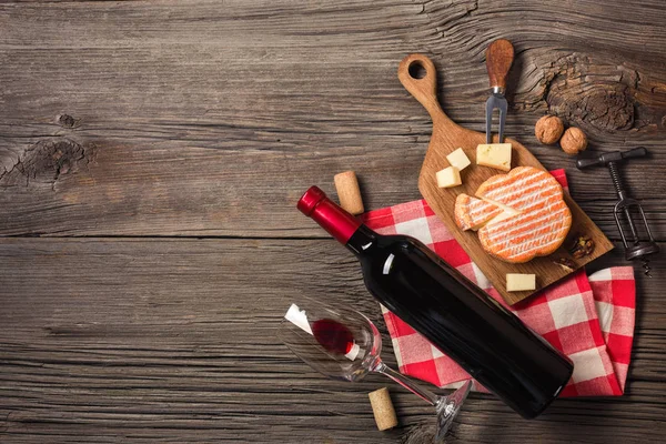 Holiday Dinner setting with red wine and creaming cheese on rustic wood. Top view with space for your greetings