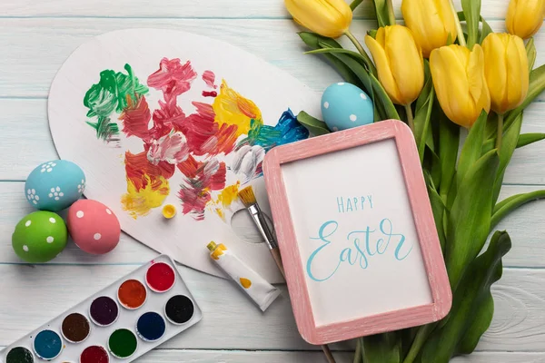 Easter Background Colorful Eggs Paints Brushes Yellow Tulips Wooden Table — Stock Photo, Image