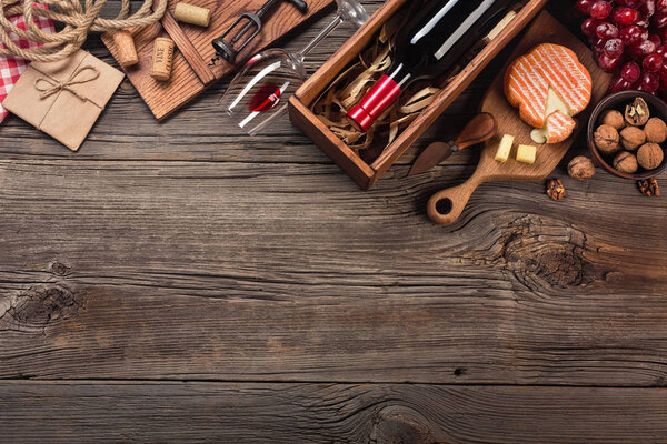 Holiday Dinner setting with red wine and creaming cheese on rustic wood. Top view with space for your greetings.