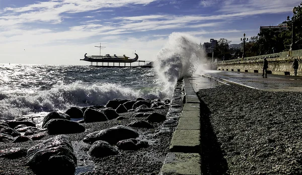 Crimea. Storm on the sea, high waves crashing on the shore. Away ship