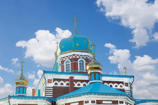 The Cathedral with Golden domes and crosses looking up into the blue sky with clouds