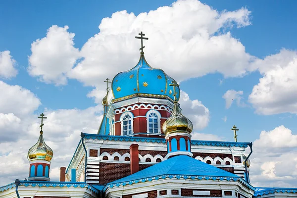 The Cathedral with Golden domes and crosses looking up into the blue sky with clouds