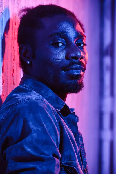 Close African American Man Earring Scars Looking Camera Colorful Neon — Stock Photo, Image