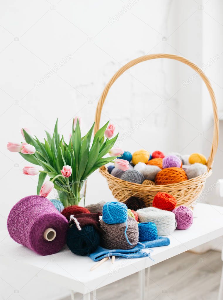 Color yarn for knitting. Knitting needles and basket with colorful yarn. 