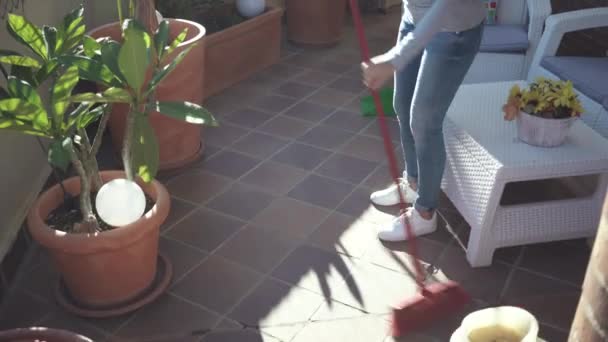 Woman with a broom cleaning floor at terrace — Stock Footage Woman with a broom cleaning floor at terrace Stock Footage