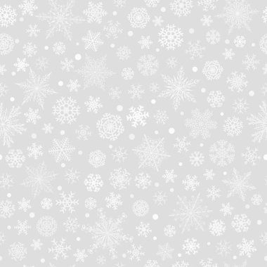 Gri arka planda beyaz, çeşitli büyük ve küçük kar tanelerinin kusursuz Noel deseni