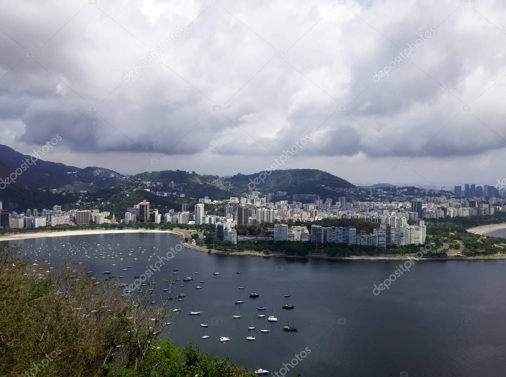 Beautiful view of the Botafogo neighborhood of Rio de Janeiro (Brazil) with a part of the Guanabara Bay. Multiple boats and yachts and white buildings with city skyline.