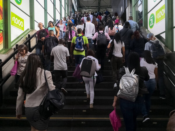 Crowd of people, in rush hour, leaving a subway metro station. Representation of mass public transport.