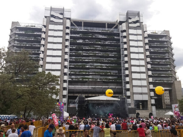 Smart building of the headquarters of the Empresas Publicas de Medellin, EPM, during an event of the Feria de las Flores with many people celebrating