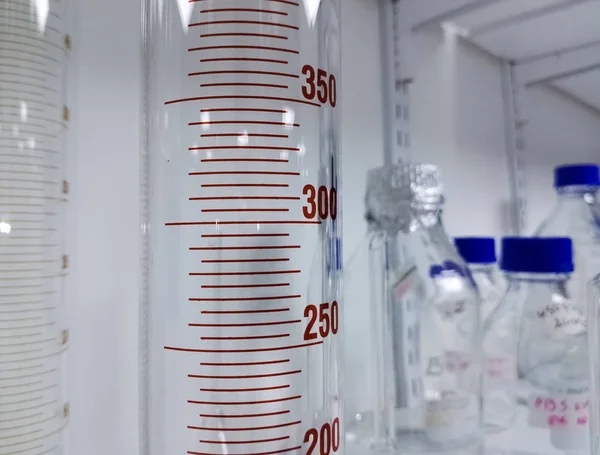 Graduated cylinder for measuring and transporting liquids and chemical substances in a laboratory. Concept of measurement in medical tests and scientific research.