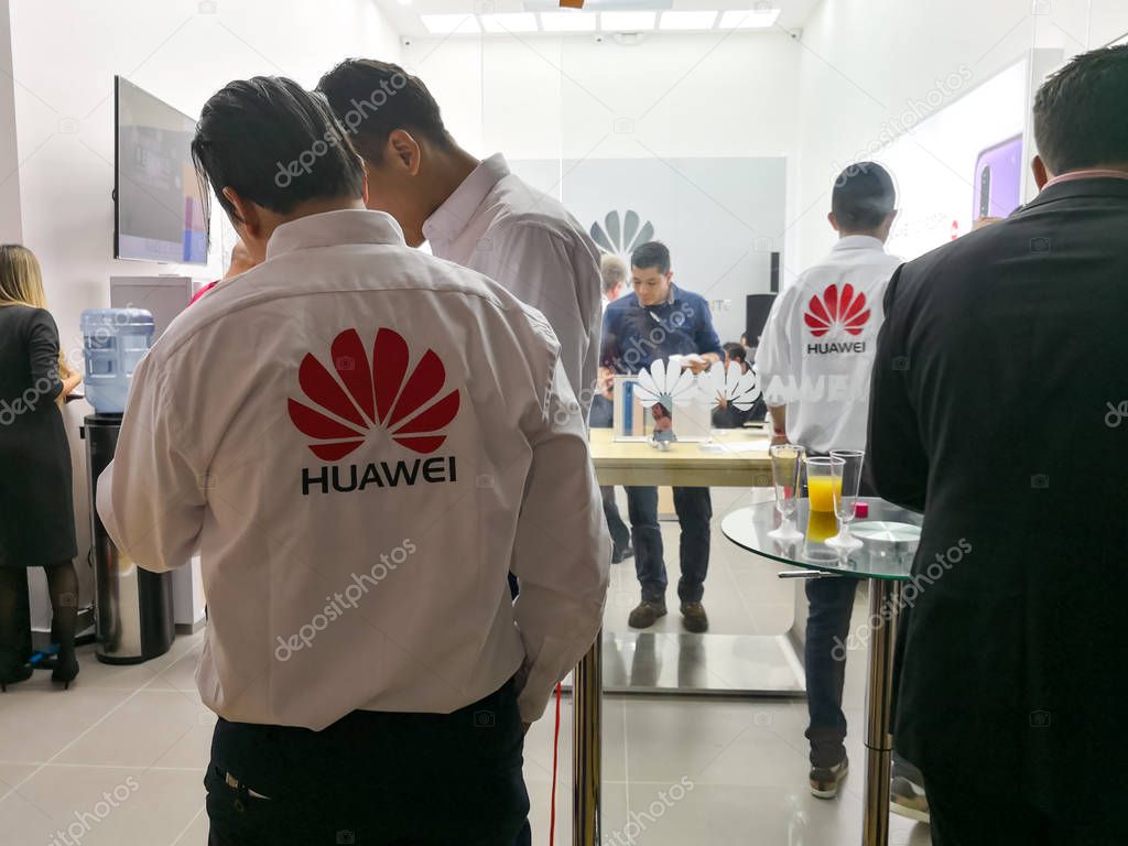 Medellin, Colombia - 10/05/2018: Huawei staff in a store of this Chinese technology brand. People buying smartphones.
