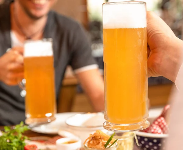 Dos Hombres Sosteniendo Jarra Cerveza Bocadillos Mesa — Foto de Stock