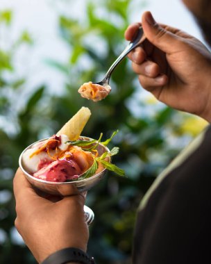 Lezzetli dondurma yiyen adam, yeşil arka plan.