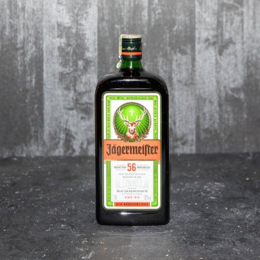 Bir şişe Jgermeister, gri arka planda alkollü içecek.