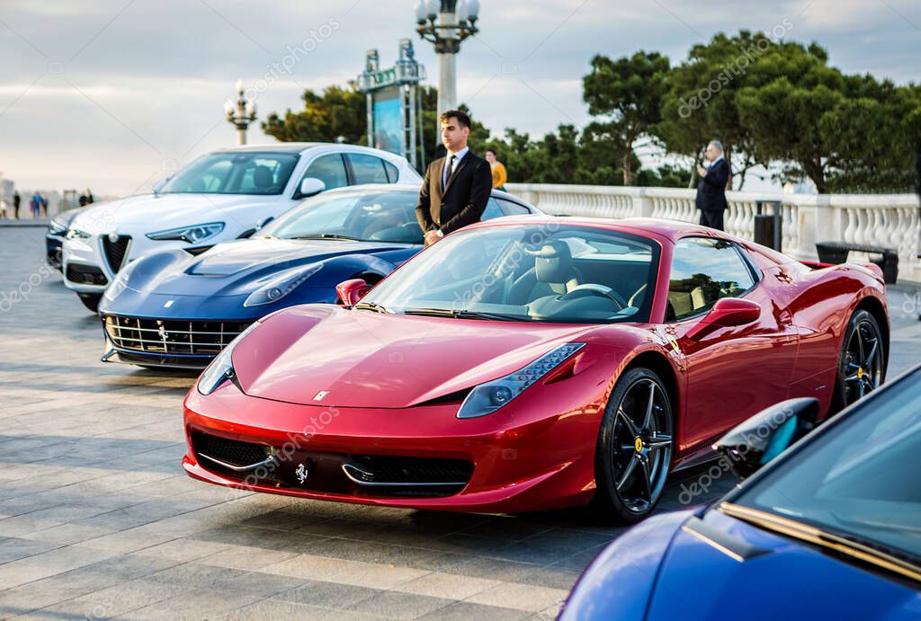 Red Ferrari at the exhibition with other sport cars