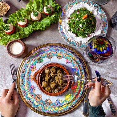 Woman eating Dolma, Azerbaijani meal top view clipart