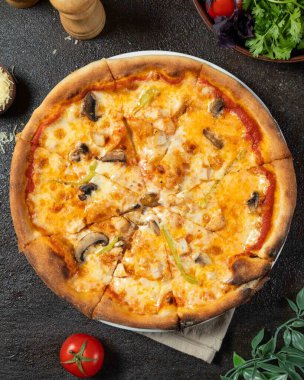 Sliced pizza with melted mozzarella, chicken, mushrooms, and green bell peppers, creating a tempting culinary scene