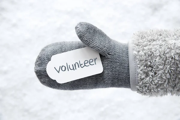 Μάλλινο γάντι, ετικέτα, χιόνι, αγγλικό κείμενο εθελοντών — Φωτογραφία Αρχείου