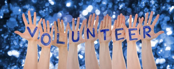 Hands Building Word Volunteer, Glittering And Sparkling Bokeh Background — Stock Photo, Image