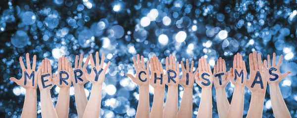 Mani costruire parola Buon Natale, scintillante sfondo Bokeh — Foto Stock