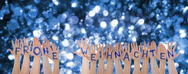 Hände bauen frohe weihnachten bedeutet frohe Weihnachten, blaues Bokeh — Stockfoto