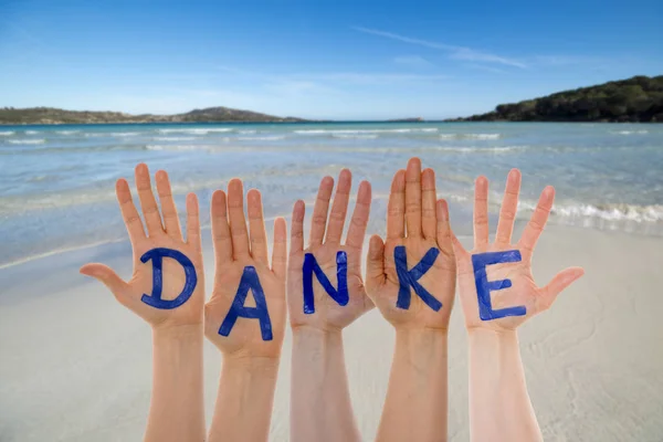 Many Hands Building Danke Means Thank You, Beach And Ocean — Stock Photo, Image