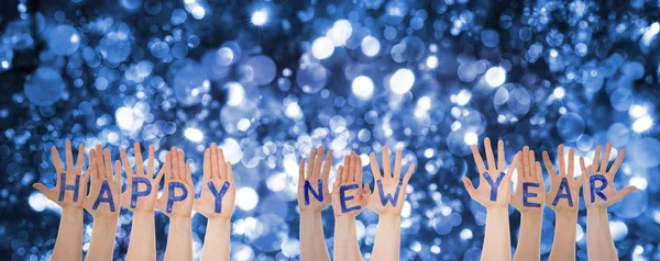 Hands Building Word Happy New Year, Glittering And Sparkling Bokeh Background — Stock Photo, Image
