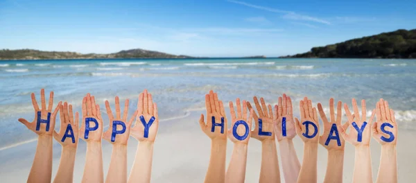 Muitas mãos construindo Palavra Boas Festas, Praia e Oceano — Fotografia de Stock